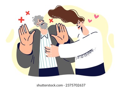 Woman tries to hug resisting man who does not want intimacy and shows stop gesture with hands. Girl wants to hug father or boyfriend with gray hair, for concept non-reciprocal romantic relationship