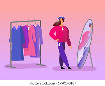 Woman tries on clothes. Autumn shopping. Looks at the mirror in the shop