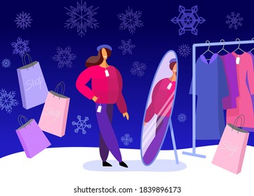 Woman tries on clothes. Winter shopping. Looks at the mirror in the shop