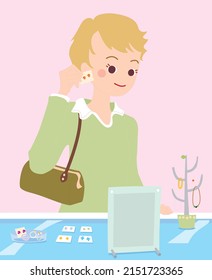 woman trying on earrings doing shopping