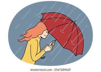 Woman with umbrella rushes home during rain and storm caused by sudden cold snap in autumn and climate change. Girl with umbrella suffers from precipitation and is afraid of getting wet