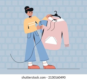 Woman use steamer iron for clothing.