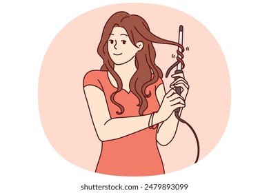 Woman uses electric curling iron to get curly hairstyle and get ready for party or date with boyfriend. Girl with curling iron wants to become beautiful giving straight hair curly look