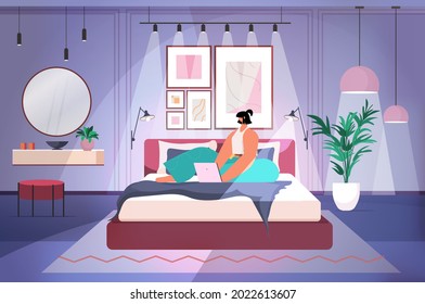 woman using laptop in dark night bedroom social media network online communication concept