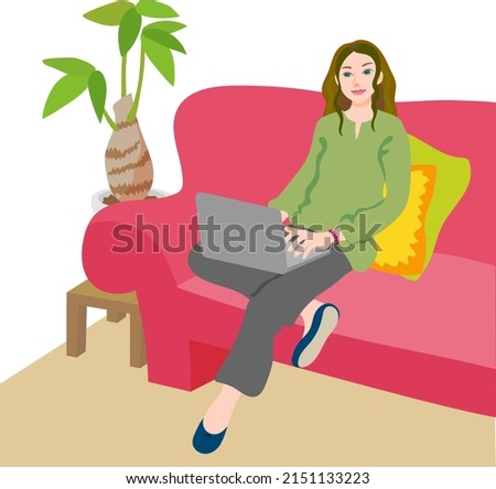 A woman using a laptop on the sofa