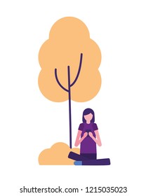 woman using mobile sitting near tree