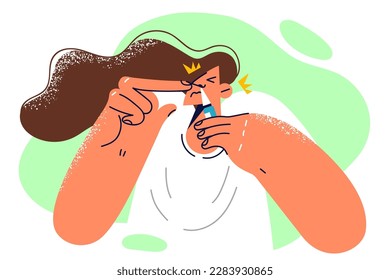 Woman is using runny nose spray during exacerbation of respiratory disease or attack of rhinitis caused by infection. Unhealthy girl with bottle of drops against runny nose uses medicinal product 