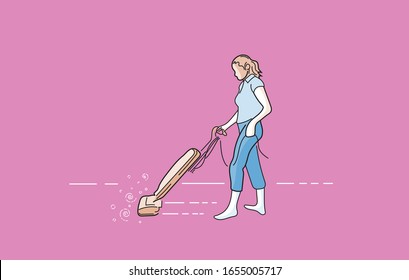 woman using an upright vacuum