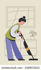 Woman vacuuming floor. Housewife is cleaning the floor with with vacuum. Woman worker of cleaning company. Household and home cleaning concept.