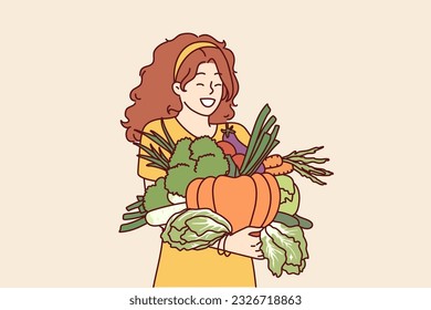 Woman with vegetables in hands rejoices good harvest or favorable prices for food at farmers market. Vegetarian girl holding organic vegetables for making healthy soups and tasty salts.