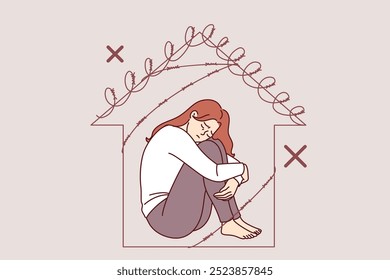 Woman victim of domestic violence sits in prison shaped like barbed wire house, in need of psychological support. Problem of domestic violence causes apathy in girl due to mental pressure from husband