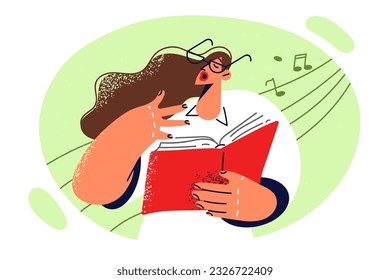 Woman vocalist holds book with notes and sings exercising vocal cords before participating in opera house concert. Girl wants to become singer and attends vocal lessons to learn sing