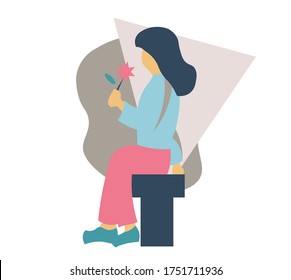 A woman is waiting for someone she likes while sitting on a bench.  She holds a flower that she has picked.