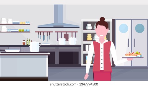 woman waitress holding tray with spaghetti meal female restaurant worker in uniform at modern commercial kitchen interior horizontal portrait flat