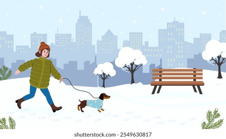 Woman walking a dog in a snowy city park during winter