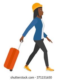 Woman walking with suitcase.