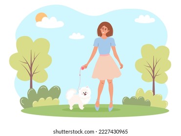 Woman walking with a white spitz dog in a park. Outdoor activity, love pets concept. 