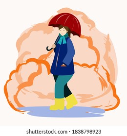 A woman walks under an umbrella through puddles in autumn