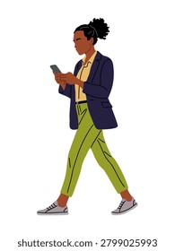 Woman walks while using her phone. She wears a blazer and vibrant pants. Her hair is styled in a neat bun. She moves confidently through her day. Perfect for urban lifestyle or tech themes