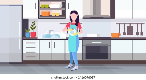 woman washing dishes housewife wiping plates with towel dishwashing concept girl in apron doing housework modern kitchen interior horizontal flat full length