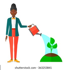 Woman watering tree.