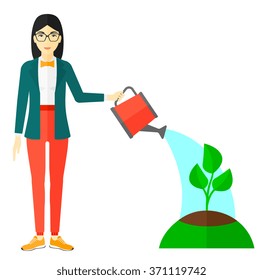 Woman watering tree.