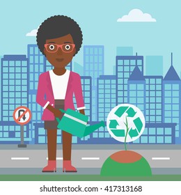 Woman watering tree with recycle sign instead of crown.