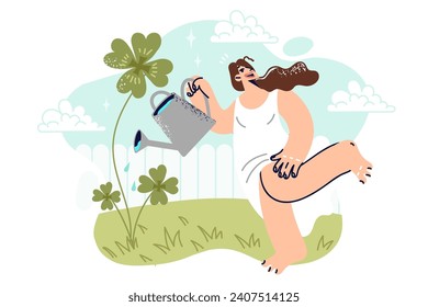 Woman waters yarrow clover in backyard, and smiles standing in short summer dress. Cheerful young girl grows clover in garden wanting to attract good luck and prepare for holiday of St. Patrick day