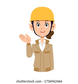 A woman wearing a beige workwear and a helmet guides