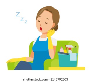 A woman wearing a blue apron and rubber gloves is falling asleep sitting on the sofa