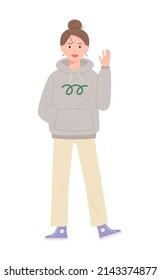 A woman wearing a hoodie is cheerfully waving her hand. flat design style vector illustration.