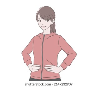 A woman wearing running wear with her hands on her hips