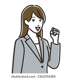 A woman wearing a suit doing a fist pump