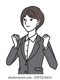 A woman wearing a suit doing a fist pump