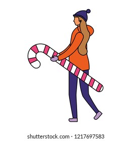 woman in winter clothes holding candy cane