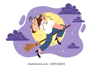 Woman witch flies on broomstick during full moon and waves hand, congratulating you on halloween. Young witch in casual clothes levitates in night sky on magic broom from fairy tale