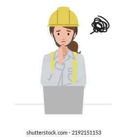 a woman working at construction sites using laptop computer having trouble with her finger on her chin at her desk