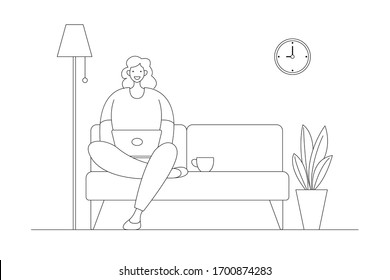 A woman working at home on some project, She is sitting on sofa at home in living room and using computer notebook for remote working.