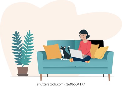 Woman working from home, Self isolating, Stay at home, Using laptop on sofa, Cat