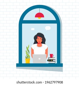 woman working at laptop from the street window. Business woman working remotely at home, sitting at a laptop on a windowsill. Lockdown, Quarantine. Freelance, online studying, work from home concept
