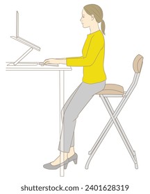 A woman working on a computer at a standing desk