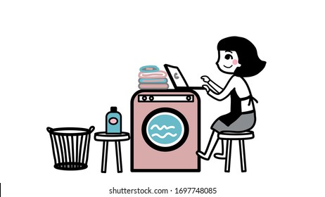 woman working on laptop during laundry time at home 