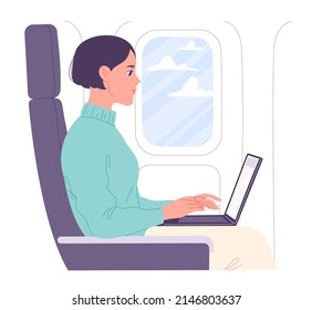 Woman working on laptop in flight cabin