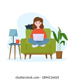 A woman works on a laptop on an armchair. Work from home concept. Freelance concept.