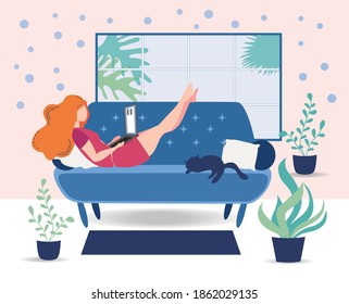A woman works on a laptop at home on the couch. Freelance concept, quarantine due to covid-19.