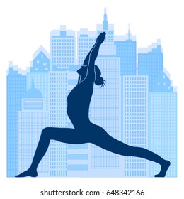 woman of yoga makes exercise on urban background