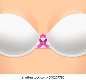 Woman's breast dressed in white bra and pink loop-shaped ribbon as symbol of breast cancer awareness