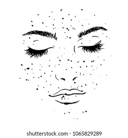 A woman's face with freckles.