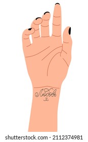 Woman's hand with black manicure and wrist tattoo. Word Love in Russian