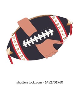 A woman's hand holding bag in the shape of an american football ball.